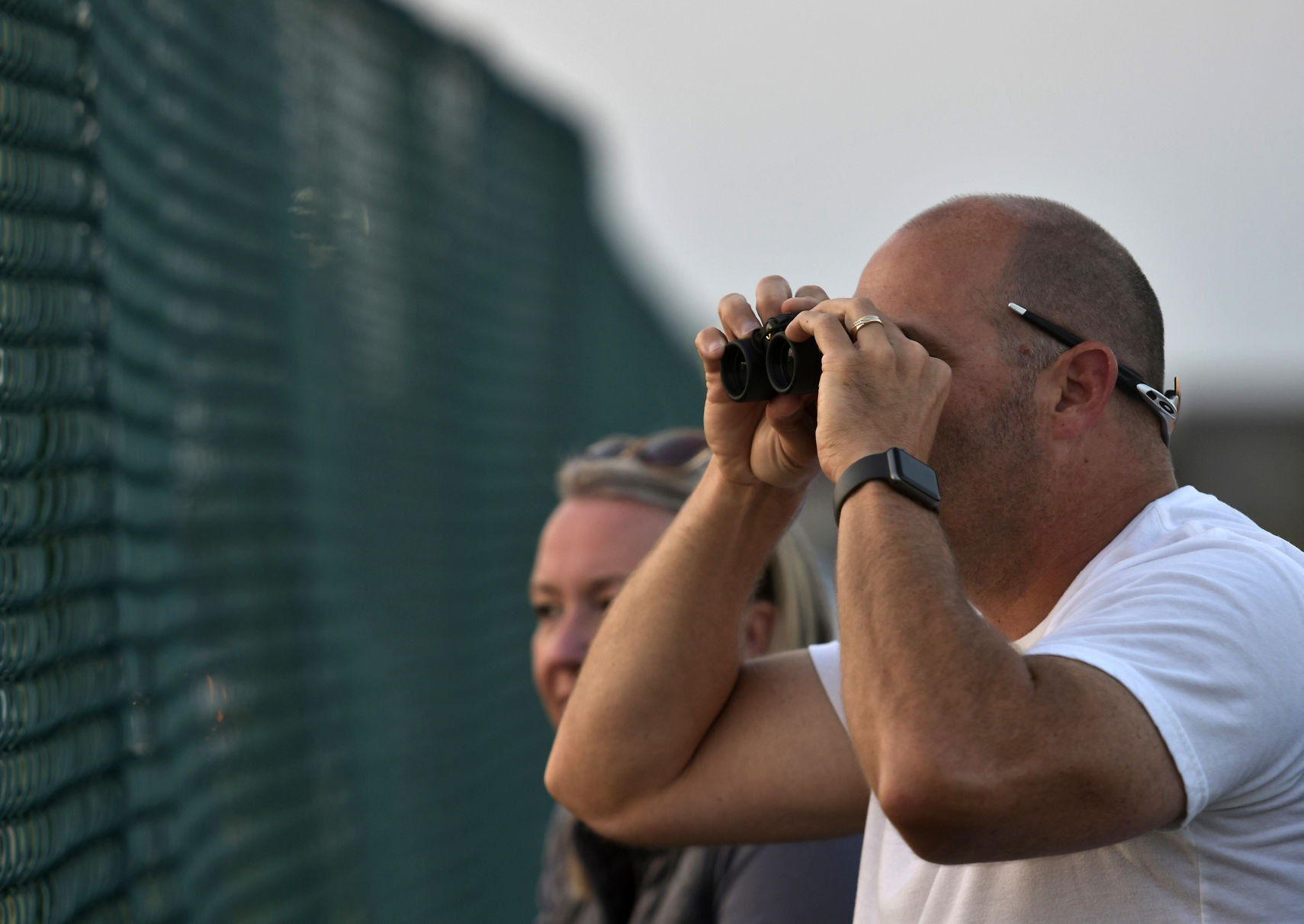WATCHING THE GAME FROM OUTSIDE THE FENCE